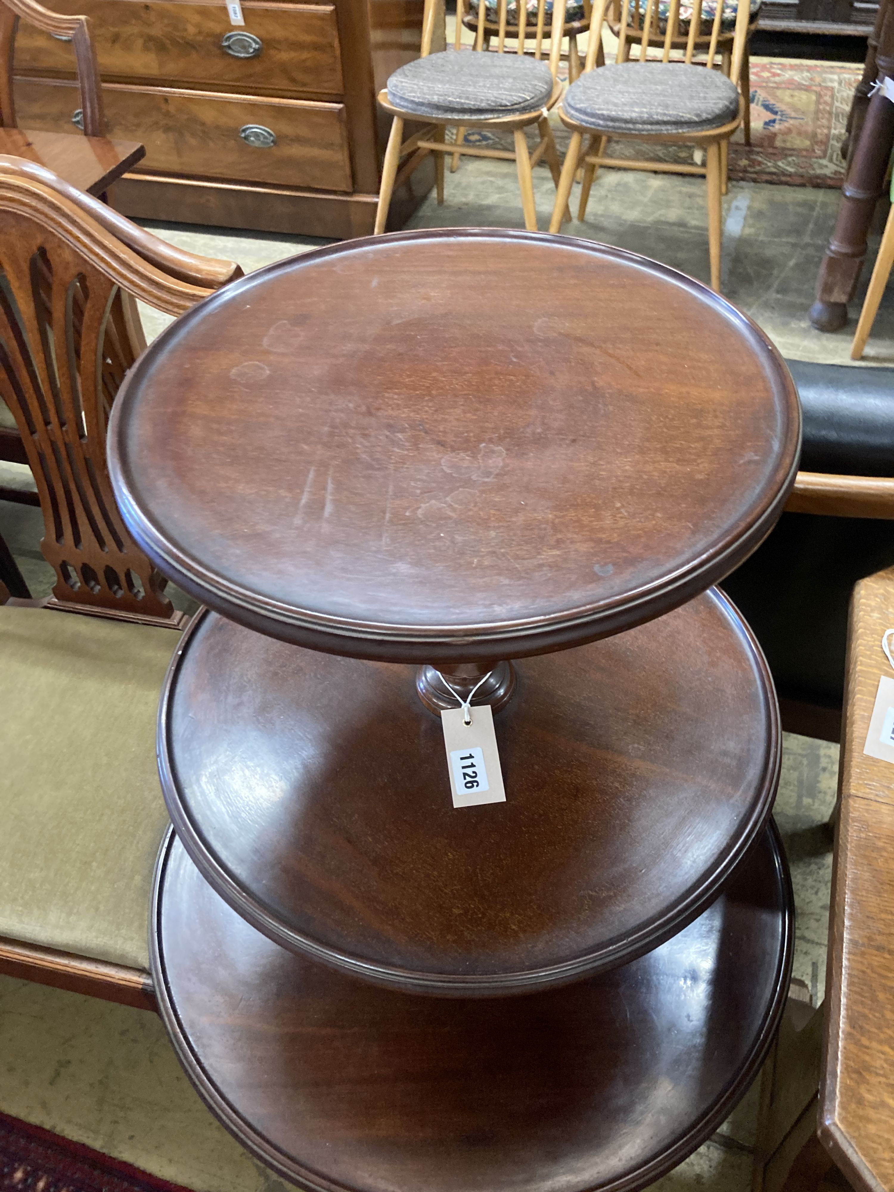 A Georgian mahogany revolving three tier dumb waiter, height 100cm